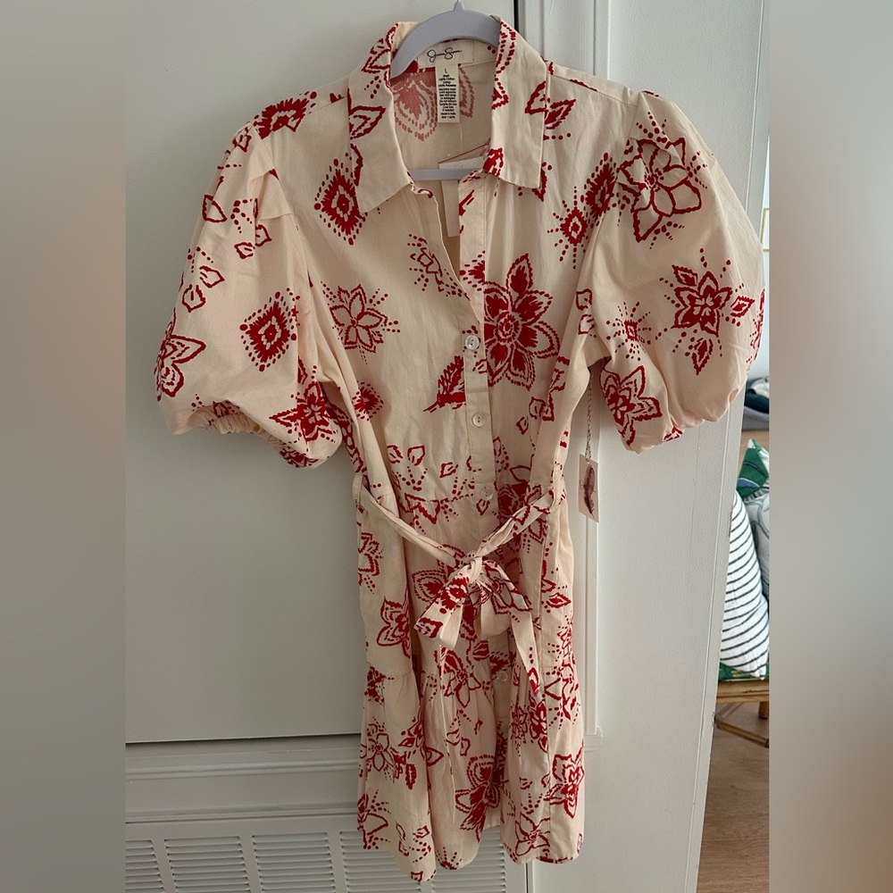 Cream dress with red print, cinched waist and puff sleeves